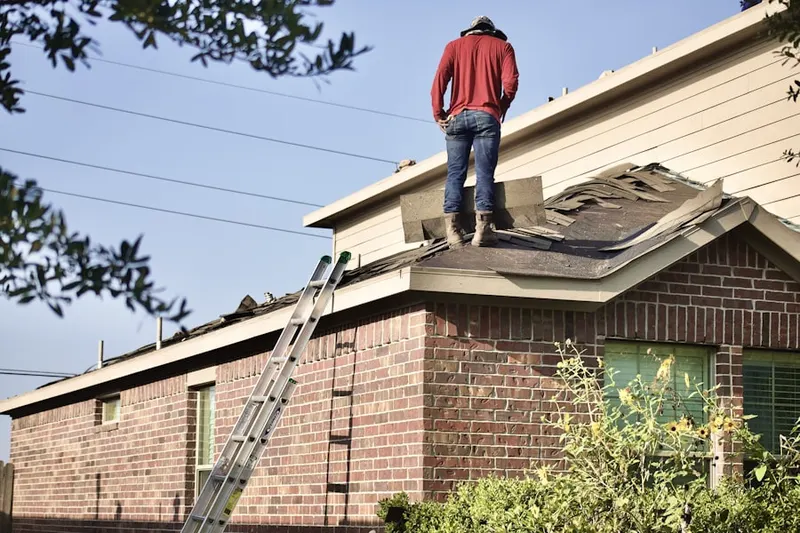 Professional roofer working on a residential roof in North Union Fort